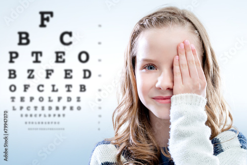 Child reviewing eyesight. photo