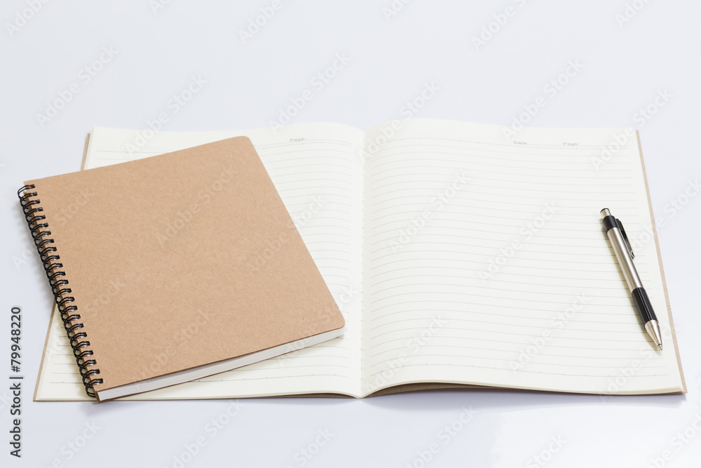 Blank notebook with a pen on white table Blank notebook with a pen on white table