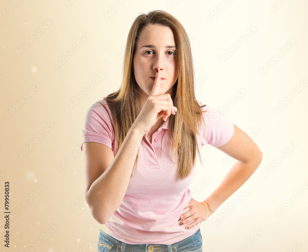 Young girl making silence gesture over isolated white background Young girl making silence gesture over isolated white background
