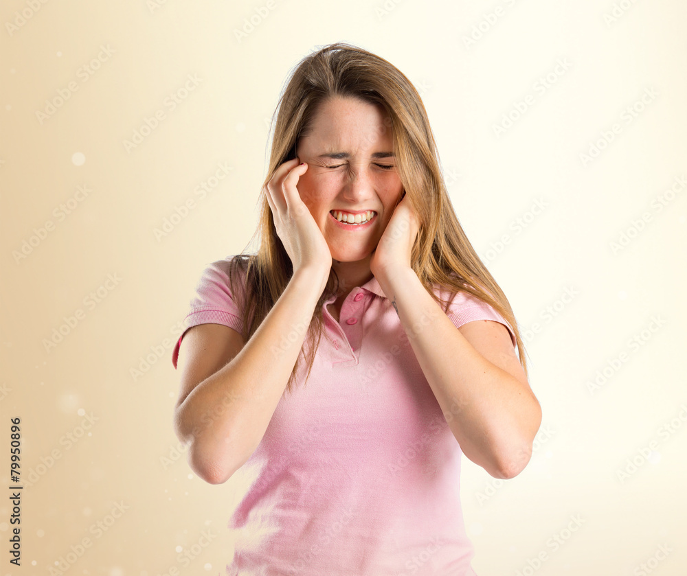 Young pretty woman covering her ears over white background Young pretty woman covering her ears over white background