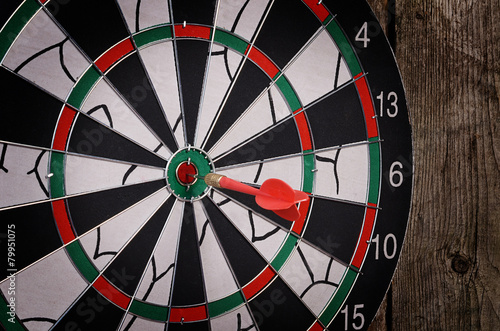 Darts on a wooden background