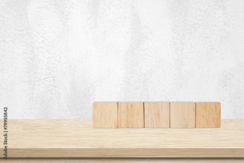 Five wooden cubes on table over white wall Five wooden cubes on table over white wall