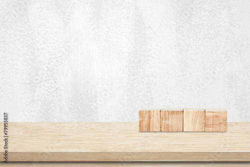 Fototapeta Naklejka Na Ścianę i Meble -  Four wooden cubes on table over white cement wall