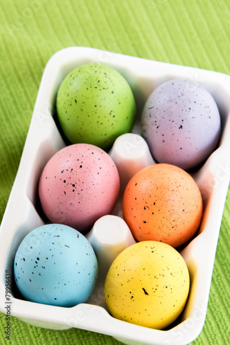 colored Easter eggs in white carton