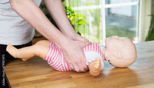 Baby CPR two hand compression photo