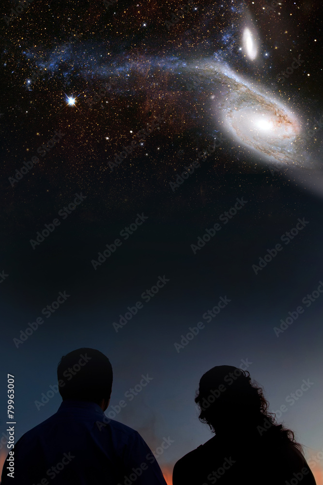 Silhouettes of couple looking at stars. Starry night sky with Silhouettes of couple looking at stars. Starry night sky with