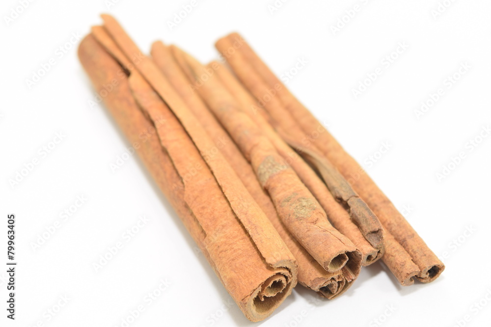 Cinnamon sticks stacked on white background. Cinnamon sticks stacked on white background.