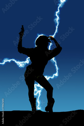 silhouette of cowgirl holding up gun behind head