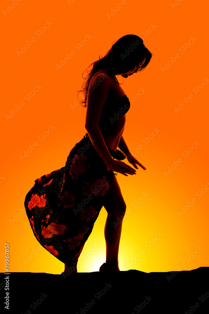 silhouette of woman in bikini and sarong side hands down