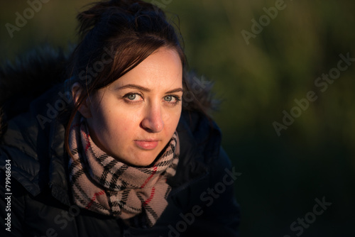 Beautiful young woman in a wheat golden field