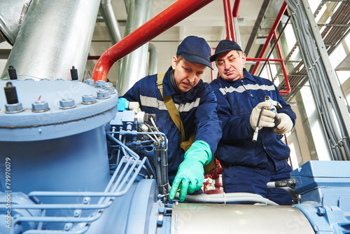 Photography service workers at industrial compressor station