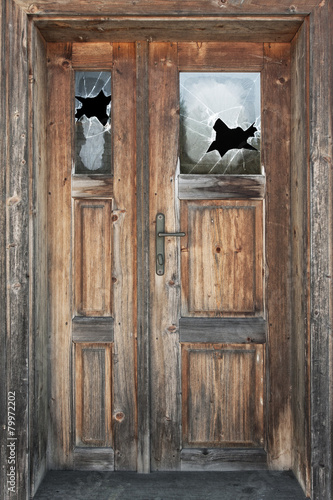 Old door with broken windows