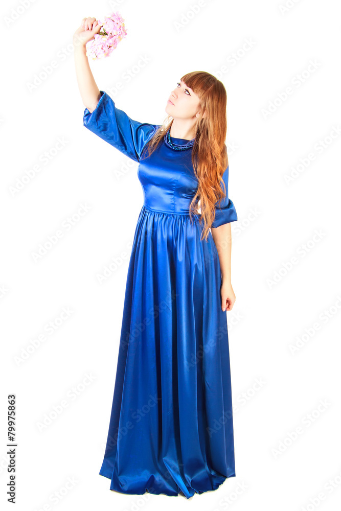 Beautiful young woman in a long blue evening dress with a small Beautiful young woman in a long blue evening dress with a small