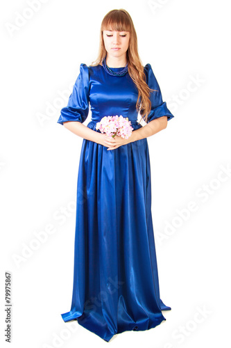 Beautiful young woman in a long blue evening dress with a small