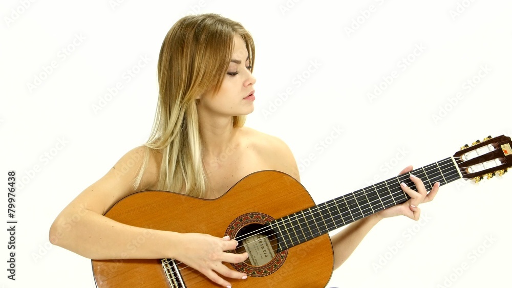 Young beautiful caucasian woman in casual playing guitar. Young beautiful caucasian woman in casual playing guitar.