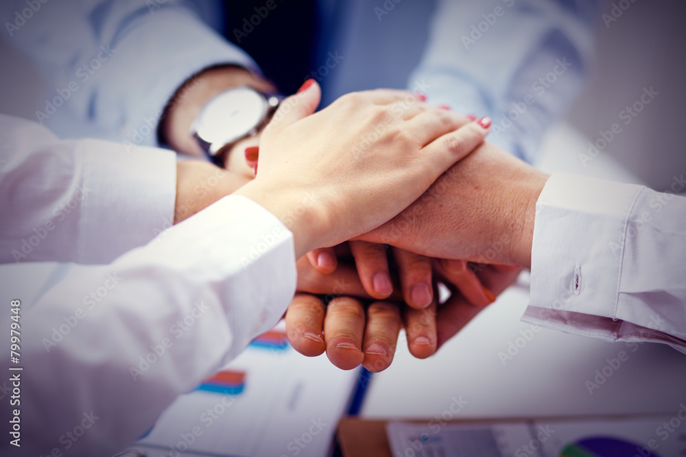 Business team are showing unity with their hands together Business team are showing unity with their hands together