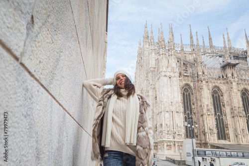 Beautiful young woman posing in the city streets