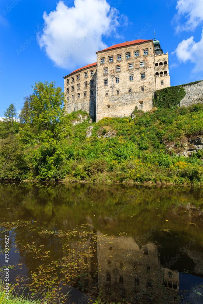 Beautiful Pieskowa Skala castle located by small lake, Poland