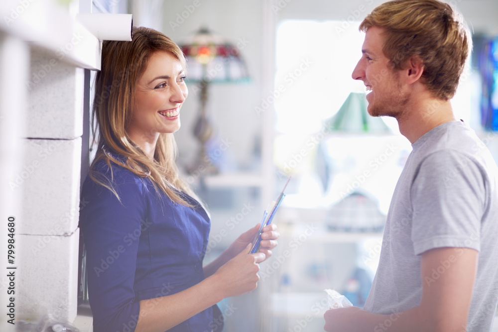 Smiling young couple in a stained glass salesroom Smiling young couple in a stained glass salesroom