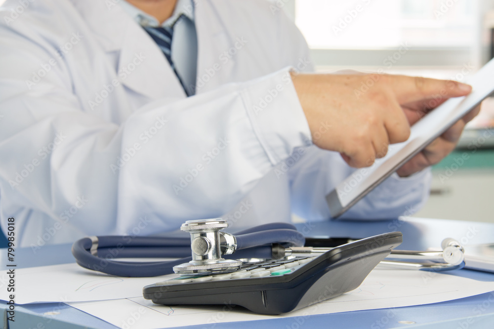 Close-up of stethoscope on background of doctors at work Close-up of stethoscope on background of doctors at work