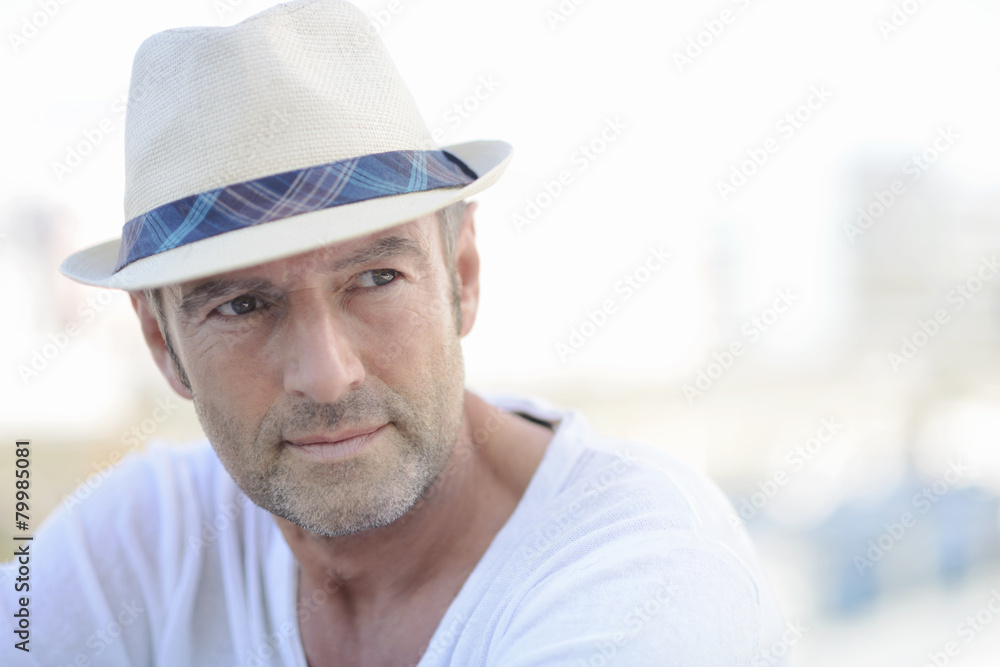 Portrait of mature man with stubble wearing summer hat Portrait of mature man with stubble wearing summer hat