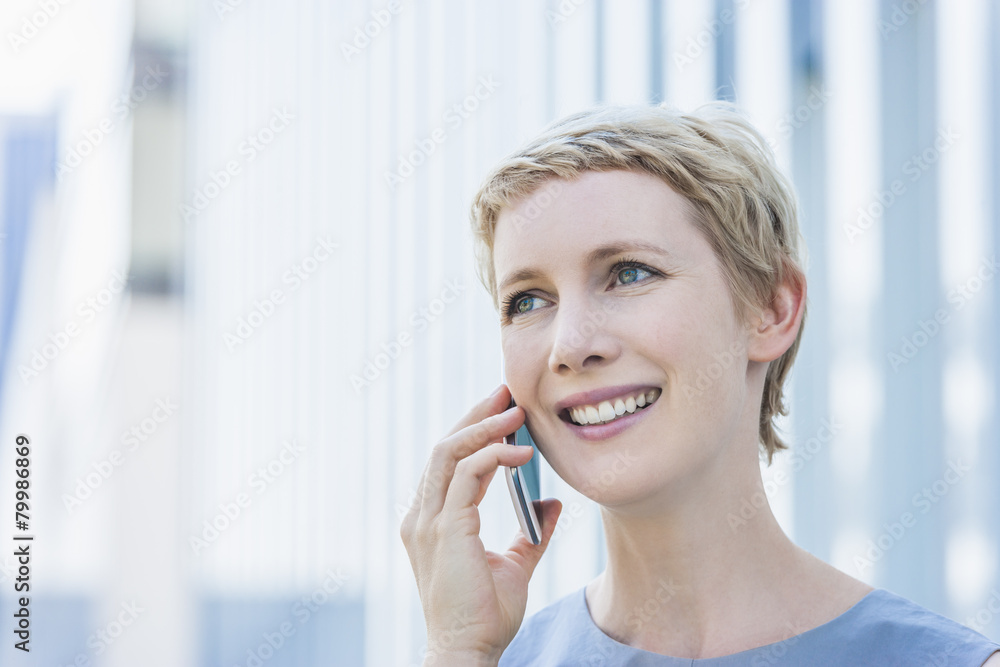 Portrait of smiling blond woman telephoning with smartphone Portrait of smiling blond woman telephoning with smartphone