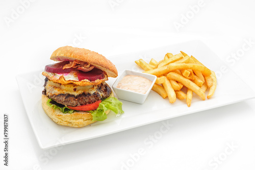 Hamburger with french fries om white plate