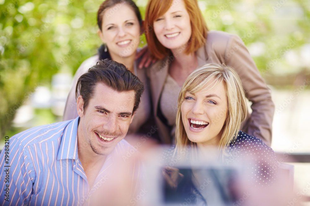 Happy friends being photographed outdoors Happy friends being photographed outdoors