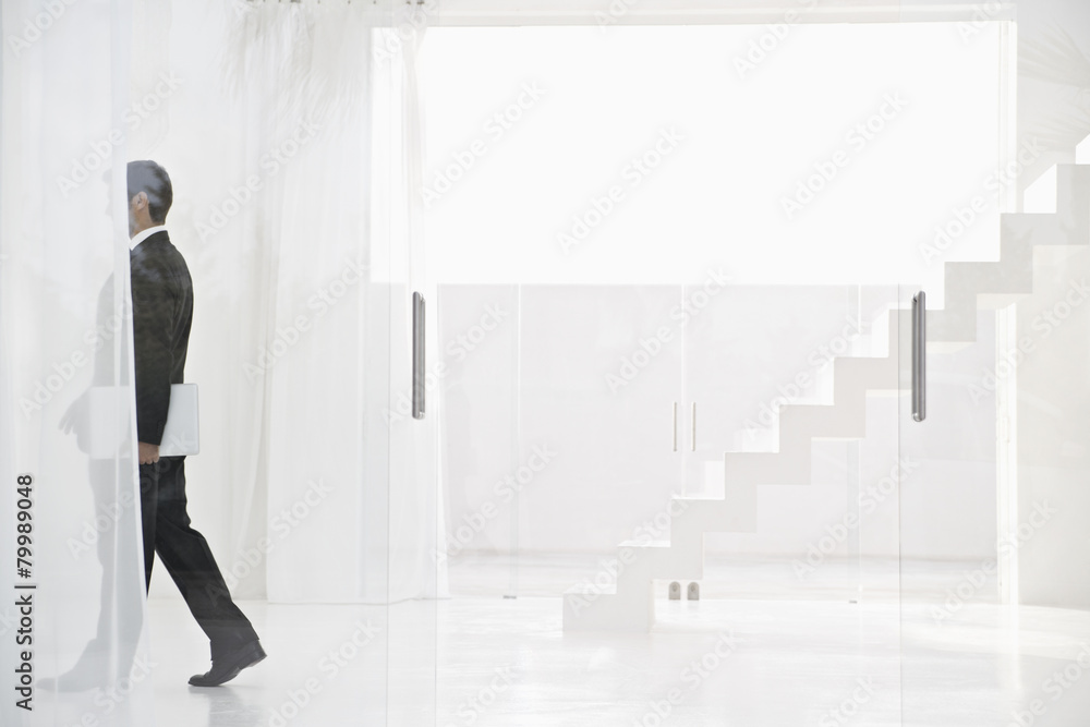Spain, Businessman walking with laptop Spain, Businessman walking with laptop