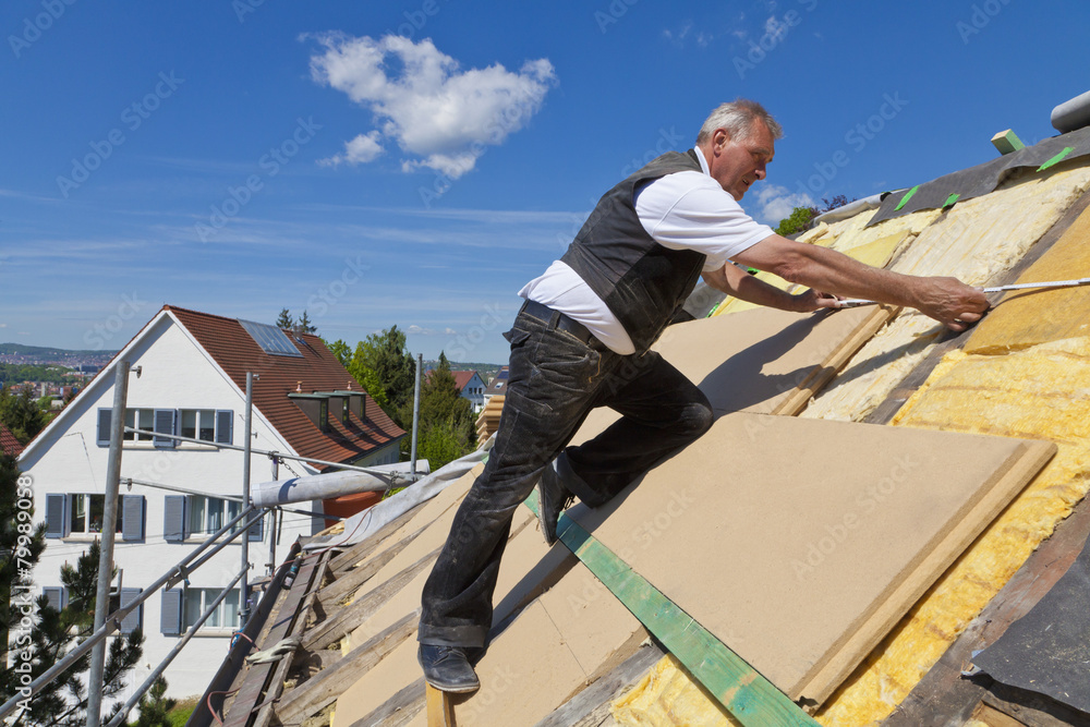Germany, Baden-Wuerttemberg, Stuttgart, Mature man placing insulation Germany, Baden-Wuerttemberg, Stuttgart, Mature man placing insulation