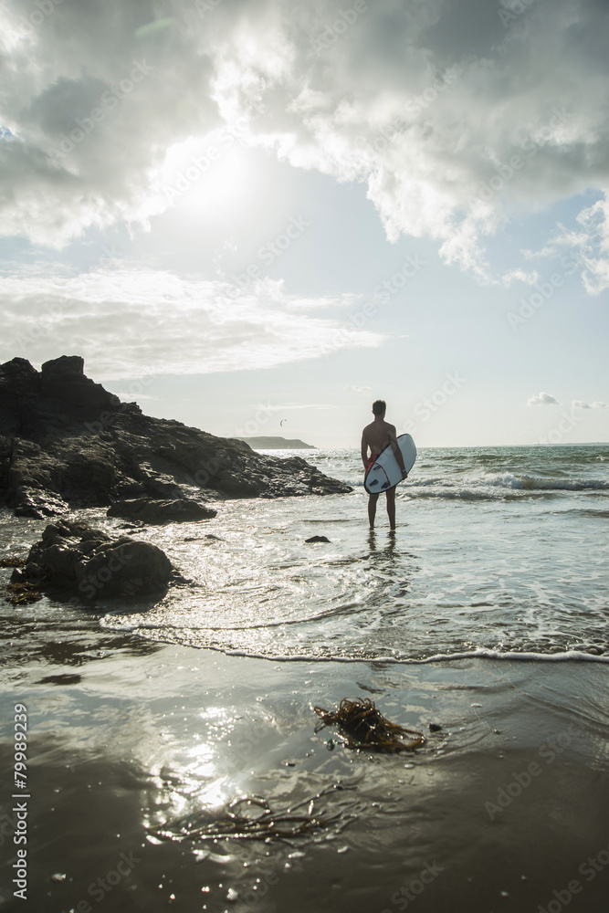 France, Brittany, Camaret-sur-Mer, teenage boy with surfboard at the ocean France, Brittany, Camaret-sur-Mer, teenage boy with surfboard at the ocean