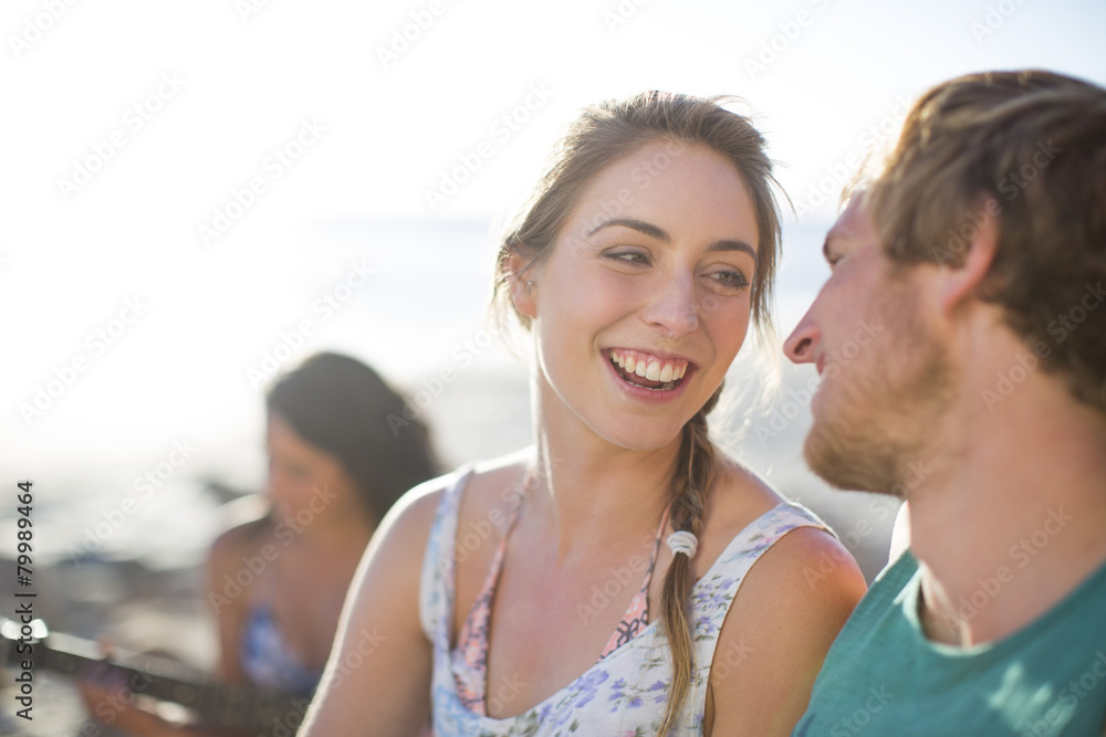 Young couple talking on the beach Young couple talking on the beach