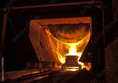 Hot steel pouring in steel plant photo