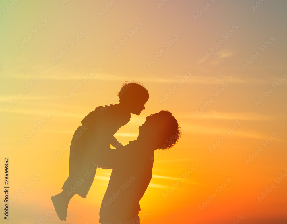 father and little son play at sunset