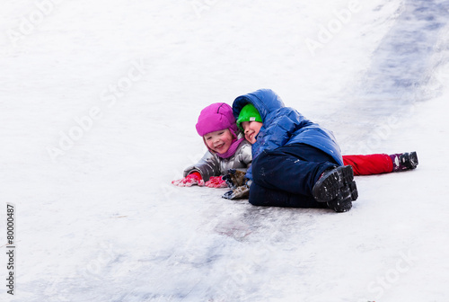 Children riding the hills in winter