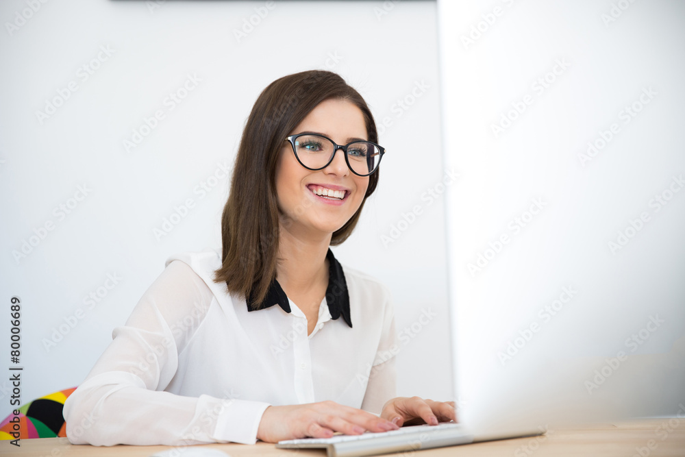 Smiling woman working on the keyboard Smiling woman working on the keyboard