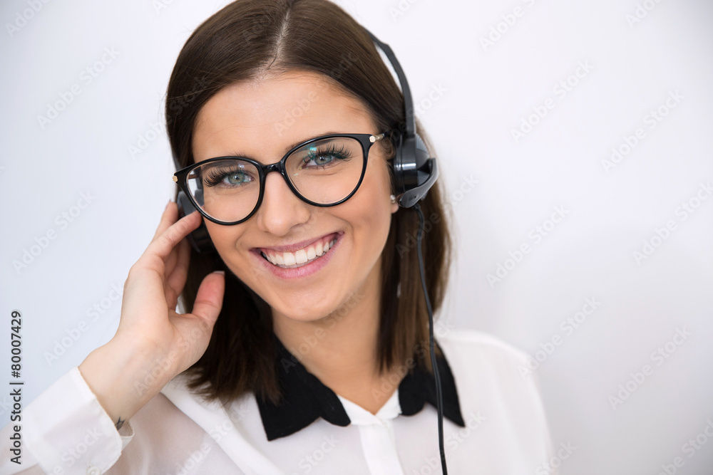 Smiling businesswoman with headset over gray background Smiling businesswoman with headset over gray background