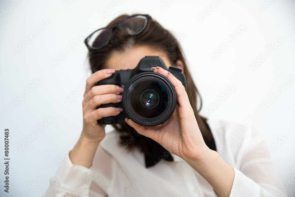 Woman photographer with camera over gray background Woman photographer with camera over gray background