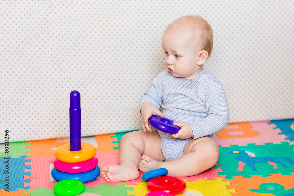 Cute little baby playing with colorful toys Cute little baby playing with colorful toys