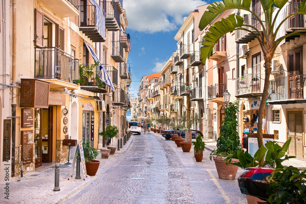 Old mediterranean steet with tourist in Cefalu, medieval city of