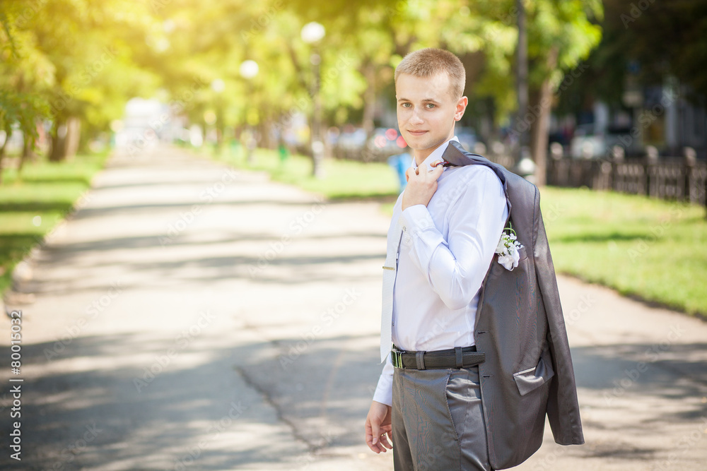 a man with a jacket over his shoulder a man with a jacket over his shoulder