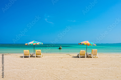 Beach umbrellas and sunbathe seats on Phuket sand beach in South © joeyphoto