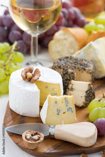 cheese platter, snacks, bread and wine, vertical, close-up
