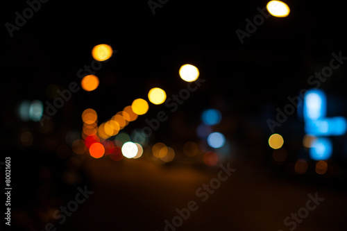 Bright circles from streetlamps on defocused photo of night stre © aradaphotography