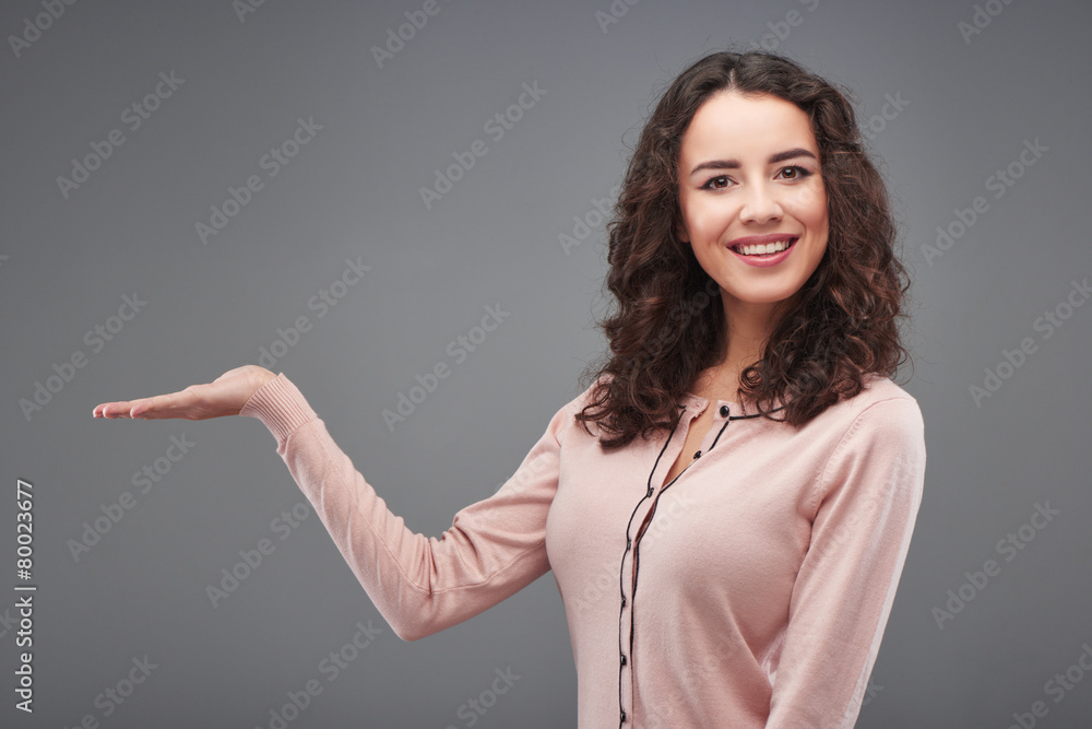 Beautiful woman looking pointing at wall Beautiful woman looking pointing at wall