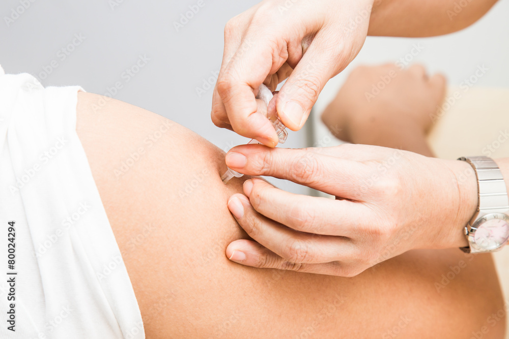 Doctor successfully injected vaccine into the arm of a patient Doctor successfully injected vaccine into the arm of a patient
