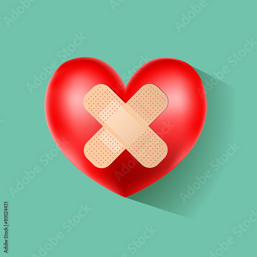 heart with plaster on green