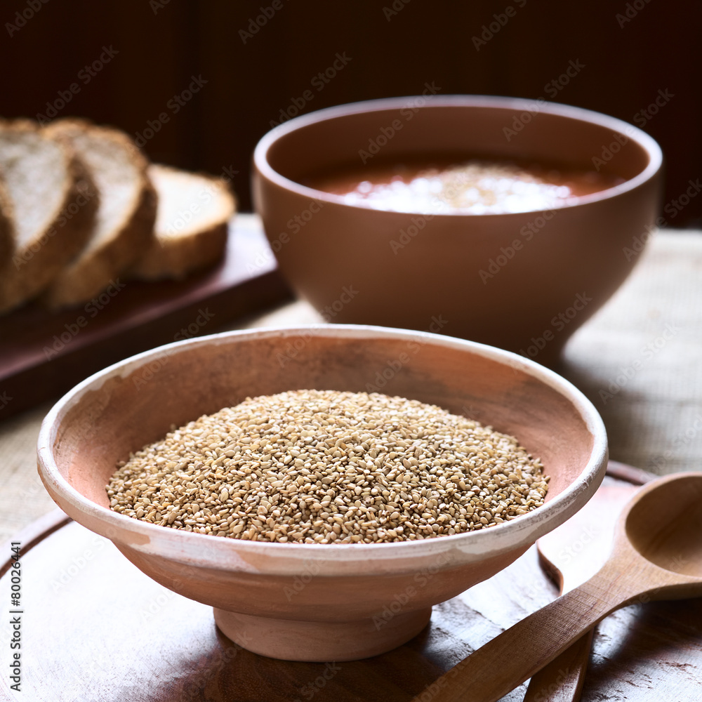Sesame seeds in bowl with vegetable cream soup in back Sesame seeds in bowl with vegetable cream soup in back