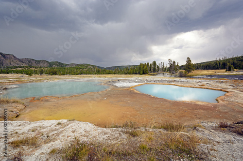 Storm Clouds over a Colorful Thermal Pool