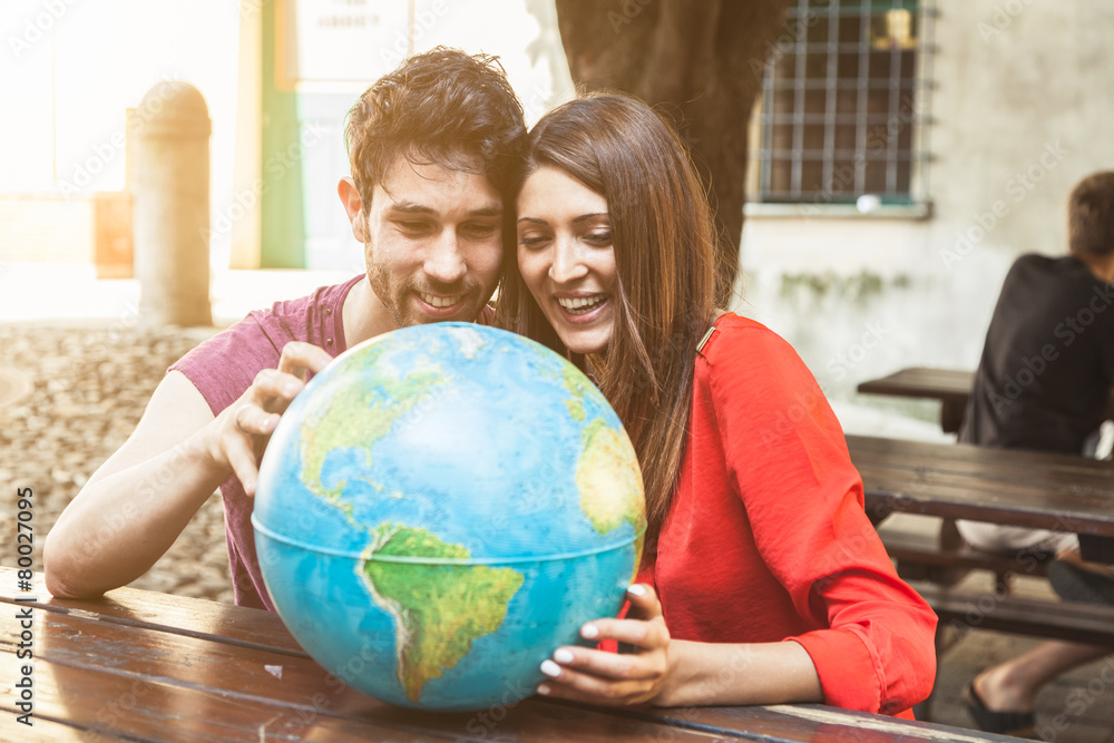 Fototapeta premium Young couple looks the world map